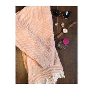 Light pink cable knit sweater with lace.